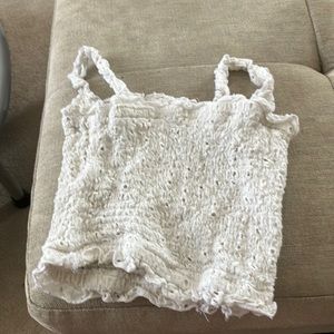 this is a very stylish white crop top, so cute !! it is a size a XS.